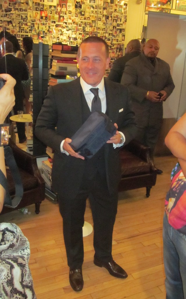 Scott Schuman holding The Satorialist for Kiehl’s Limited Edition Dopp Kit